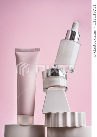 Skincare set with peeling mask, serum, and eye cream on pink background Skincare set with peeling mask, serum, and eye cream on pink background 132139711