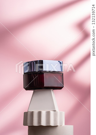 Elegant cosmetic jar on geometric pedestal with pink background Elegant cosmetic jar on geometric pedestal with pink background 132139714
