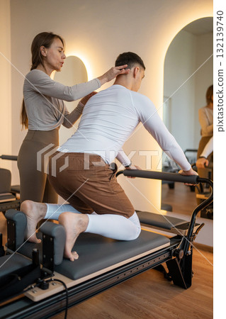 Engaging Pilates Training Sessions Held in a Stylish and Modern Studio Environment Engaging Pilates Training Sessions Held in a Stylish and Modern Studio Environment 132139740