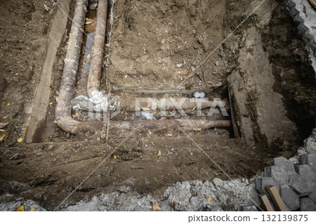 Construction work reveals underground pipes during a renovation project in a city Construction work reveals underground pipes during a renovation project in a city 132139875