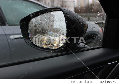 Car overtakes another car on a wet road with a metal fence. Dangerous overtaking of a car on a rain slick road at speed Car overtakes another car on a wet road with a metal fence. Dangerous overtaking of a car on a rain slick road at speed 132140070