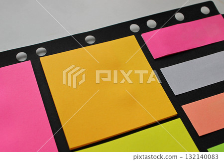 Sticky Color Paper Pad for Office and Education Notes on a White Table Close Up Stock Photo Sticky Color Paper Pad for Office and Education Notes on a White Table Close Up Stock Photo 132140083