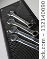 Set of mechanical wrenches on a black rubber stand. Arrangement of tools at the mechanic's workplace 132140090