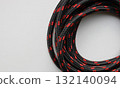 Wire wrapped in silk and twisted into a loop isolated on white flat lay. Silk wire wound in circle form with empty space 132140094