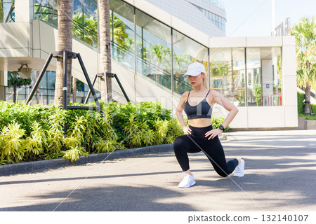 Sport woman performs outdoor exercise, fit people enjoy workout, stretch routine in urban setting promotes daily healthy sport lifestyle for wellness. 132140107