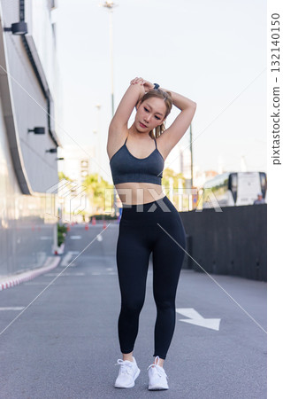 Stretch woman performs outdoor sport exercise workout, arm stretch for flexibility, fit people maintain healthy body strength, promoting overall wellness and active lifestyle. 132140150