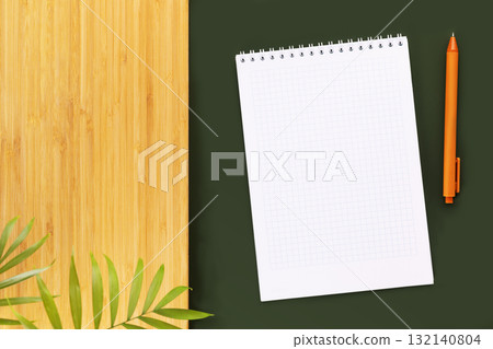 Eco friendly, natural background. Green table with notepaper with white blank sheet for your text and wooden board with home plants. Mock up for inscription and recipes. Flat lay Eco friendly, natural background. Green table with notepaper with white blank sheet for your text and wooden board with home plants. Mock up for inscription and recipes. Flat lay 132140804