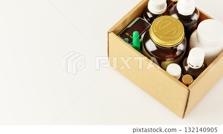 Carton box with set of medicines and vitamins. Humanitarian aid for refugees on a white background with copy space. Medicine donations concept and Volunteering and charity for refugees Carton box with set of medicines and vitamins. Humanitarian aid for refugees on a white background with copy space. Medicine donations concept and Volunteering and charity for refugees 132140905