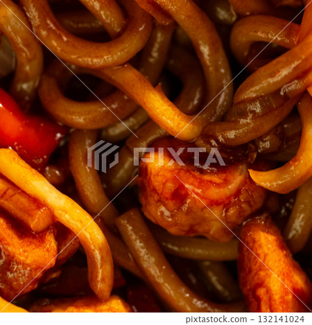 Udon stir-fry noodles with chicken and vegetables, close up. 132141024