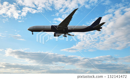 Airplane flying preparing for landing against a blue sky with clouds, travel and aviation 132141472