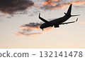 Airplane landing silhouette against a colorful sunset sky, travel and aviation concept 132141478