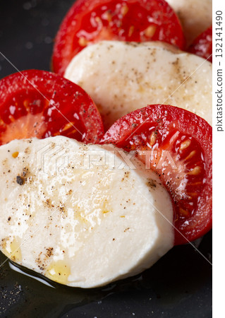 Classic Italian caprese salad with mozzarella, tomato, and olive oil 132141490