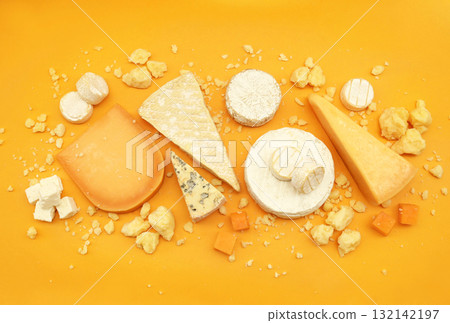 Colorful mix of cheese varieties: brie and camembert, blue gorgonzola and parmesan, gauda and cheddar. Food ingredients background Colorful mix of cheese varieties: brie and camembert, blue gorgonzola and parmesan, gauda and cheddar. Food ingredients background 132142197