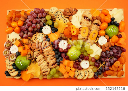 Healthy Halloween fun food mix: cheese ghosts and mummies, banana ghosts and grapes, blueberries and blackberries. Party spooky snacks for kids 132142216