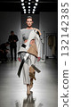 High fashion model in a futuristic avant-garde outfit walks the catwalk at a fashion show 132142385