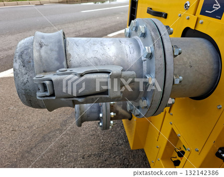 Close-up view of a sturdy hose connection attached to a sewage disposal vehicle. This fitting is essential for effective pumping of waste and ensures safe disposal. Close-up view of a sturdy hose connection attached to a sewage disposal vehicle. This fitting is essential for effective pumping of waste and ensures safe disposal. 132142386