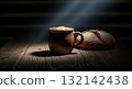 Rustic still life with a clay mug of frothy beer and a loaf of bread on a wooden table 132142438