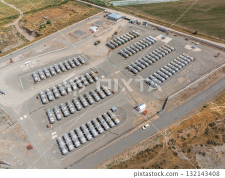Industrial storage tanks arranged in rows at rural facility Industrial storage tanks arranged in rows at rural facility 132143408
