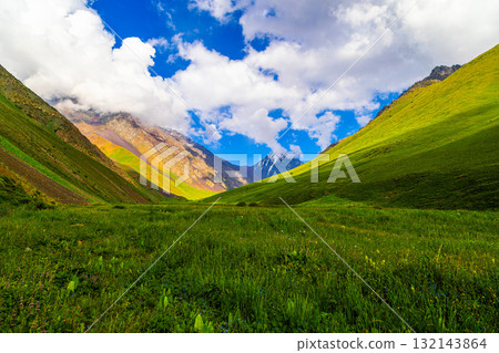 Majestic mountains and serene valley under blue sky in Kyrgyzstan 132143864