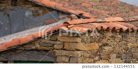 Rustic Stone House Roof with Terra Cotta Tiles 132144555