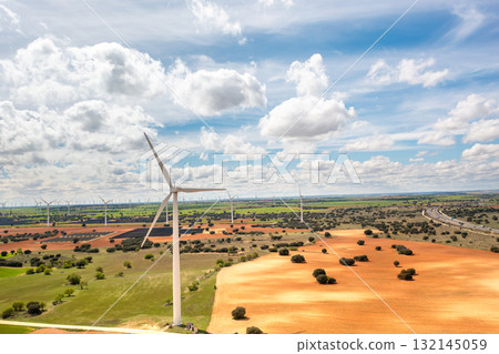 Wind turbines spanning across vast rural landscape 132145059