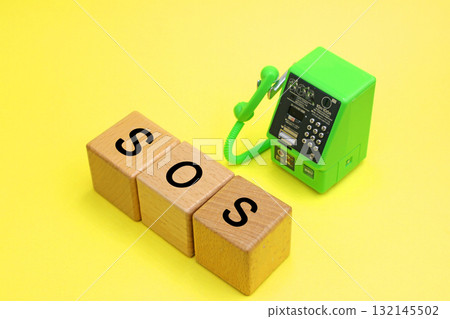 Public telephone and a block with the word SOS written on it 132145502
