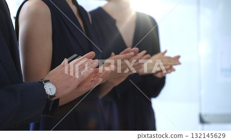 Group of business people clapping hands celebrating achievement, showing appreciation and support during a corporate meeting or seminar at a bright office conference Group of business people clapping hands celebrating achievement, showing appreciation and support during a corporate meeting or seminar at a bright office conference 132145629