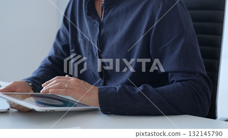 Businessman working with digital tablet and laptop computer at office desk, analyzing financial data and reports, developing business plan and strategy. Business people concept Businessman working with digital tablet and laptop computer at office desk, analyzing financial data and reports, developing business plan and strategy. Business people concept 132145790