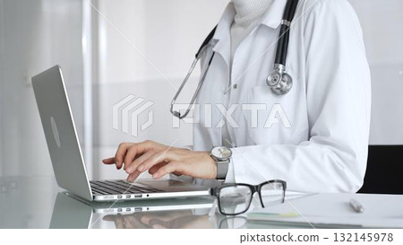 Healthcare professional working on laptop, providing digital medicine consultation and tele health service. Medicine, healthcare and science concept 132145978