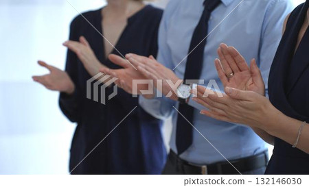 Businesspeople applauding, showing appreciation and celebrating success during a corporate event, conference, or team meeting in an office environment. Business people concept Businesspeople applauding, showing appreciation and celebrating success during a corporate event, conference, or team meeting in an office environment. Business people concept 132146030