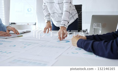 Business team analyzing financial charts during strategy meeting, professionals discussing data and performance metrics at workplace for decision making success Business team analyzing financial charts during strategy meeting, professionals discussing data and performance metrics at workplace for decision making success 132146165