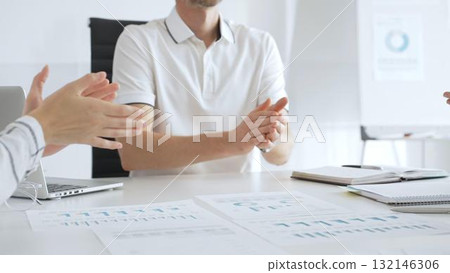 Professional business people team clapping hands, celebrating successful presentation, displaying collaborative spirit in modern office Professional business people team clapping hands, celebrating successful presentation, displaying collaborative spirit in modern office 132146306