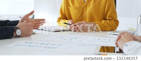 Business professionals discussing financial charts, collaborating on data analysis and strategic planning in contemporary workplace setting with graphs and reports Business professionals discussing financial charts, collaborating on data analysis and strategic planning in contemporary workplace setting with graphs and reports 132146357