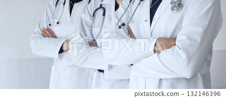 A group of doctors with folded arms demonstrates the professionalism of medicine, mutual support of clinics, and dedication to expert care in a hospital setting A group of doctors with folded arms demonstrates the professionalism of medicine, mutual support of clinics, and dedication to expert care in a hospital setting 132146396