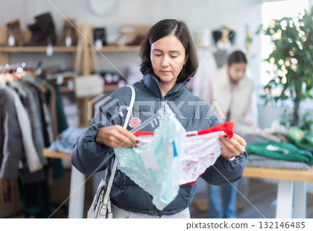 Adult woman chooses panties in clothing store Adult woman chooses panties in clothing store 132146485