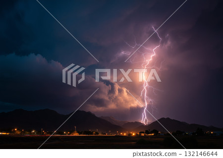 Lightning cutting through the night sky: the moment of storm and thunder 132146644