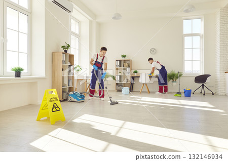 Group of young happy male people in uniform wiping, washing and vacuuming client house or office. Group of young happy male people in uniform wiping, washing and vacuuming client house or office. 132146934
