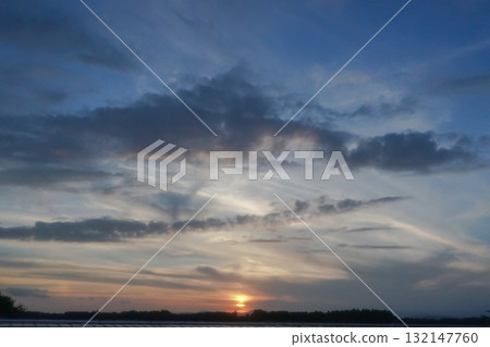 sunset seen through clouds 132147760