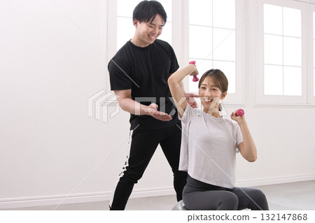 年輕女子正在接受私人教練的訓練 年輕女子正在接受私人教練的訓練 132147868