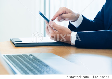 A businessman handling a smartphone hand 132148444