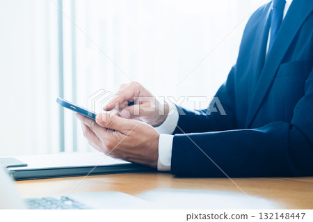 A businessman handling a smartphone hand 132148447
