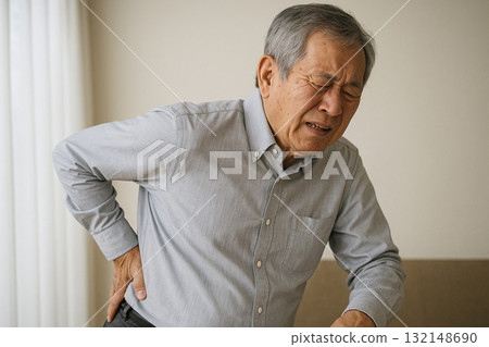 A person with a painful expression and hands on their hips A person with a painful expression and hands on their hips 132148690