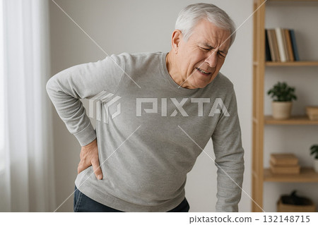 A person with a painful expression and hands on their hips A person with a painful expression and hands on their hips 132148715
