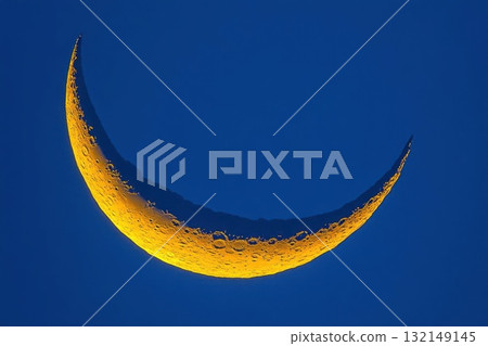 Crescent moon against a blue sky. Concept of night, astronomy, and nature. Crescent moon against a blue sky. Concept of night, astronomy, and nature. 132149145