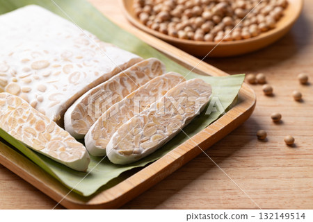 Tempeh made from fermented soybeans wrapped by banana leaf, Traditional Indonesian food Tempeh made from fermented soybeans wrapped by banana leaf, Traditional Indonesian food 132149514
