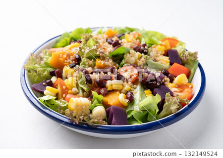 Healthy vegetable salad bowl on white background. Vegan and plant-based food 132149524