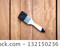 Paint brush and wood material in construction work. 132150236