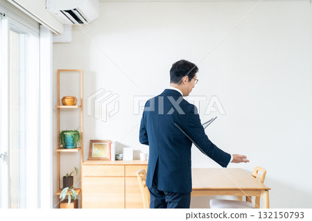 A man in a suit checking furniture 132150793