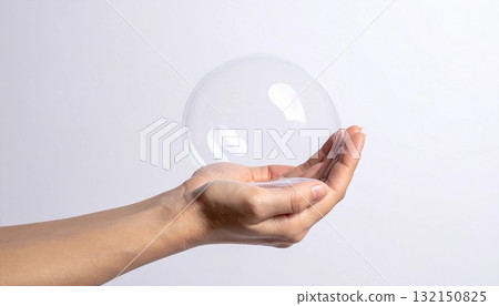 A transparent soap bubble gently wrapped in both hands. Generative AI 132150825