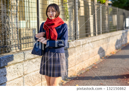 High school girl going to and from school on a cold day. High school student wearing winter clothes and carrying a hand warmer. Blazer. Going to and from school. Trimmed up. High school girl going to and from school on a cold day. High school student wearing winter clothes and carrying a hand warmer. Blazer. Going to and from school. Trimmed up. 132150862